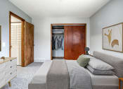 Thumbnail 11 of 25 - a bedroom with a bed and a dresser