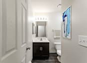 Thumbnail 21 of 22 - A bathroom with a white sink and a white toilet.