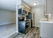 Thumbnail 6 of 25 - a kitchen with stainless steel appliances and a white counter top
