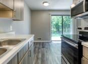 Thumbnail 8 of 25 - a kitchen with white countertops and stainless steel appliances