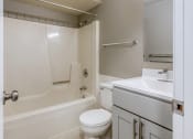 Thumbnail 19 of 25 - a bathroom with a toilet sink and bathtub