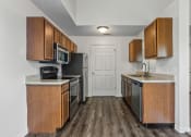 Thumbnail 24 of 24 - a kitchen with wooden cabinets and stainless steel appliances and a door