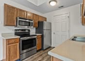 Thumbnail 23 of 24 - a kitchen with stainless steel appliances and wooden cabinets