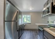 Thumbnail 4 of 22 - a kitchen with stainless steel appliances and brown cabinets
