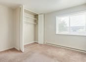 Thumbnail 11 of 22 - a bedroom with a large window and a closet
