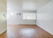 Thumbnail 7 of 22 - a living with hardwood floors and white walls