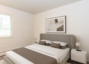 Thumbnail 4 of 22 - A bedroom with a large bed and a picture on the wall.