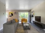 Thumbnail 2 of 22 - a living room with a couch and a coffee table