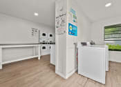Thumbnail 56 of 56 - a laundry room with white appliances and a counter at 5636 Apartment Homes, Dallas, 75254