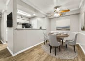 Thumbnail 31 of 56 - a dining room with a table and chairs and a ceiling fan at 5636 Apartment Homes, Dallas, TX