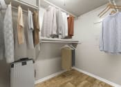 Thumbnail 45 of 56 - the preserve at ballantyne commons closet with robes and clothes hanging on a rack at 5636 Apartment Homes, Dallas, TX, 75254