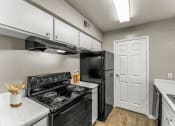 Thumbnail 35 of 56 - a kitchen with a stove refrigerator and sink at 5636 Apartment Homes, Dallas, 75254