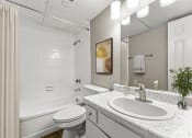 Thumbnail 41 of 56 - a bathroom with a sink and a toilet and a tub at 5636 Apartment Homes, Dallas, Texas