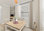 Thumbnail 26 of 56 - a dining room with a table and chairs and a large window at 5636 Apartment Homes, Dallas