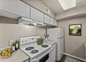 Thumbnail 22 of 56 - our apartments have a kitchen with white appliances and granite counter tops at 5636 Apartment Homes, Dallas, TX