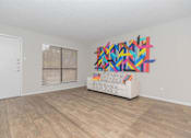 Thumbnail 43 of 68 - a living room with a couch and a painting on the wall at The Escapade, San Antonio, TX