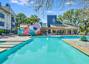 Thumbnail 3 of 15 - a swimming pool with a building in the background at Peaks at Northwest Hills Apartments, Texas, 78731