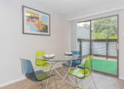Thumbnail 42 of 68 - a dining room with a glass table and chairs and a large window at The Escapade, San Antonio, 78216