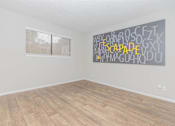 Thumbnail 45 of 68 - an empty room with wood floors and a window at The Escapade, San Antonio