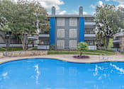 Thumbnail 32 of 68 - a large swimming pool with an apartment building in the background at The Escapade, San Antonio, 78216