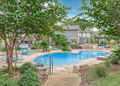 Thumbnail 28 of 68 - a swimming pool with trees and chairs around it at The Escapade, San Antonio, Texas