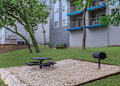 Thumbnail 27 of 63 - our apartments have a picnic area with a grill and a picnic table at The Keller, San Antonio, TX  