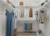 Thumbnail 12 of 68 - a walk in closet with a rack of clothes and a blue dress at The Escapade, San Antonio