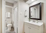 Thumbnail 10 of 68 - a bathroom with a toilet and a sink and a mirror at The Escapade, San Antonio, Texas