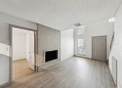 Thumbnail 59 of 60 - the living room and dining room of an apartment with a fireplace