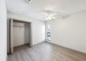 Thumbnail 52 of 60 - an empty room with a closet and a ceiling fan