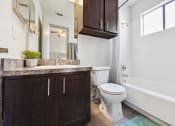 Thumbnail 57 of 60 - a bathroom with a toilet and a sink and a bath tub
