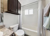 Thumbnail 60 of 60 - a bathroom with a toilet and a sink and a shower