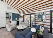 Thumbnail 8 of 60 - Clubhouse with a blue couch and a coffee table at Maxwell Townhomes, San Antonio, 78230