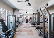 Thumbnail 23 of 40 - A gym with treadmills, weights, and exercise equipment.