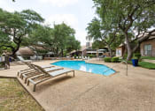 Thumbnail 44 of 47 - Pool with lounge chairs and trees at Carmel at Deerfield, Texas
