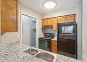 Thumbnail 5 of 19 - A kitchen with a sink, stove, and refrigerator at Knoll Crest, San Antonio, Texas 78240