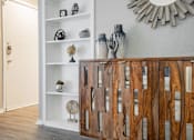 Thumbnail 8 of 41 - a living room with a wooden cabinet and a mirror on the wall at Aero White Rock, Dallas, TX