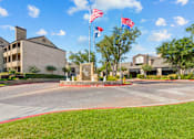 Thumbnail 14 of 40 - A building with a flag on top of it.