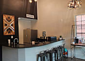 Thumbnail 6 of 20 - A kitchen with a black counter top and a white wall.