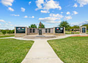 Thumbnail 39 of 40 - A monument surrounded by plaques is in the middle of a grassy area.