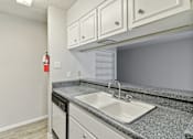 Thumbnail 52 of 68 - the kitchen of our A4 apartment atrium with white cabinets and a sink at The Escapade, San Antonio, 78216