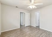 Thumbnail 53 of 68 - a spacious bedroom with white walls and a ceiling fan at The Escapade, San Antonio, Texas