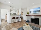 Thumbnail 5 of 40 - A modern living room with a fireplace and a bar area.