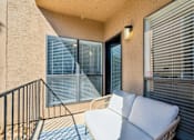 Thumbnail 13 of 40 - A balcony with a white sofa and a black railing.
