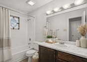 Thumbnail 6 of 43 - A bathroom with a white toilet, a white sink, and a white shower curtain.