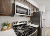 Thumbnail 2 of 43 - A kitchen with a black stove top oven and a black refrigerator.