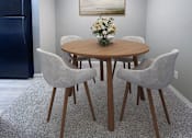 Thumbnail 23 of 28 - A dining room with a round table and chairs.