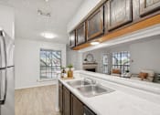 Thumbnail 3 of 43 - A kitchen with a stainless steel refrigerator and a marble countertop.