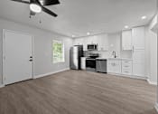 Thumbnail 68 of 79 - the living room and kitchen of a home with white walls and white cabinets at Sunset Heights, San Antonio, TX, 78209
