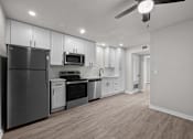Thumbnail 60 of 79 - an empty kitchen with white cabinets and stainless steel appliances at Sunset Heights, Texas